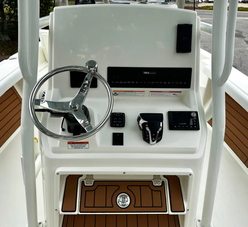 Slide: The Image of 2025 Pathfinder 2400TRS boat console with steering wheel and controls. - 12
