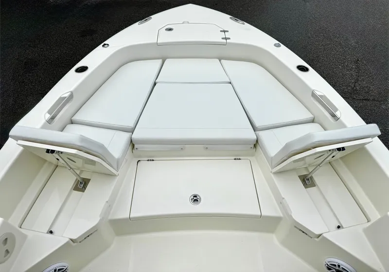 Slide: The Image of 2025 Pathfinder 2400TRS boat interior with cushioned seating and storage compartments. - 14