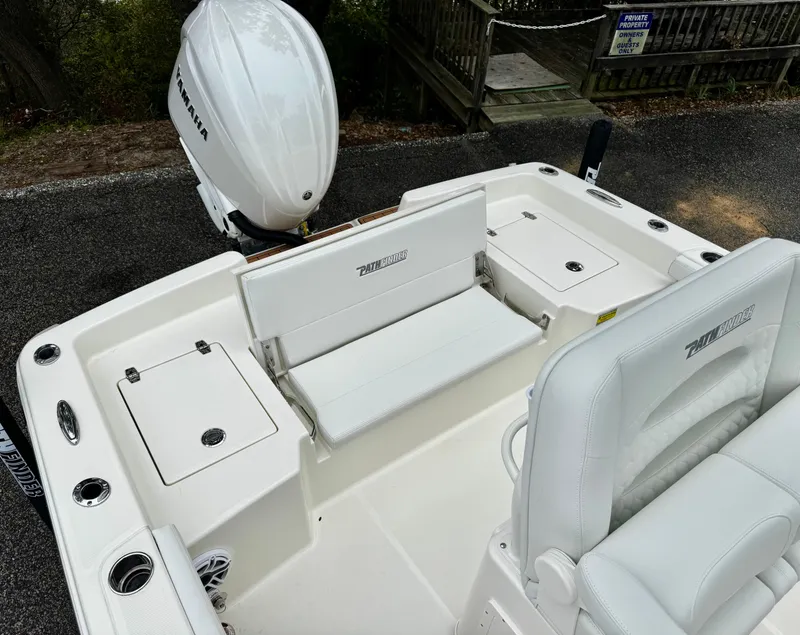 Slide: The Image of 2025 Pathfinder 2400TRS boat interior with Yamaha engine, featuring white seating and storage compartments. - 7