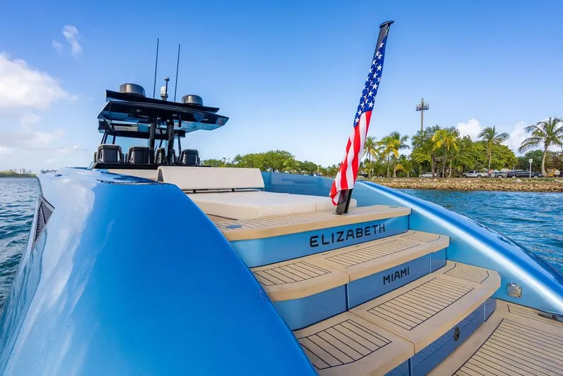 Slide: The Image of 2022 Wajer 55 S yacht with American flag, docked in Miami waters. - 15