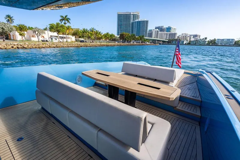 Slide: The Image of Wajer 55 S 2022 yacht with elegant seating, cruising near a coastal cityscape. - 17