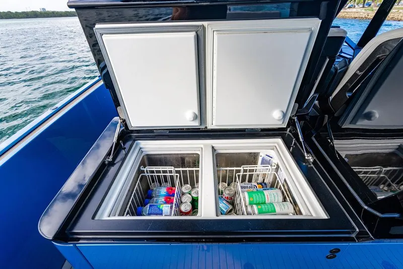 Slide: The Image of Open cooler on 2022 Wajer 55 S yacht, stocked with beverages, against a scenic water backdrop. - 19