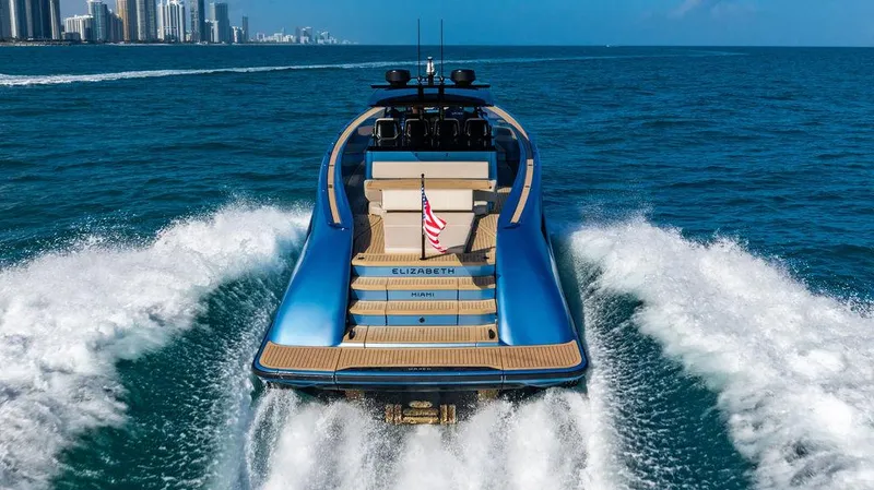 Slide: The Image of Luxury Wajer 55 S yacht cruising in ocean, 2022 model, city skyline in background. - 2