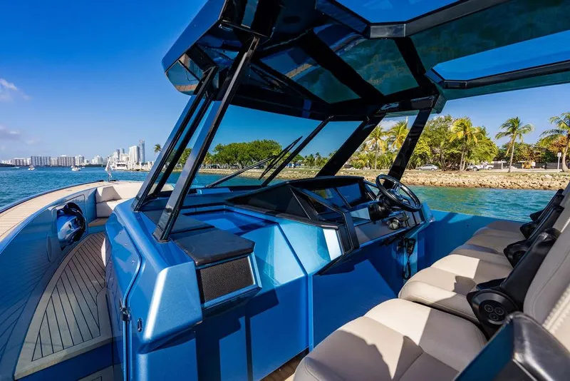 Slide: The Image of 2022 Wajer 55 S yacht cockpit with luxurious seating and modern design, cruising near a tropical shoreline. - 27