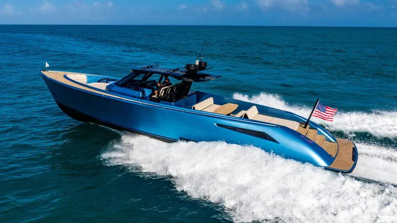 Slide: The Image of 2022 Wajer 55 S yacht cruising on open sea, sleek design, blue hull, American flag displayed. - 3