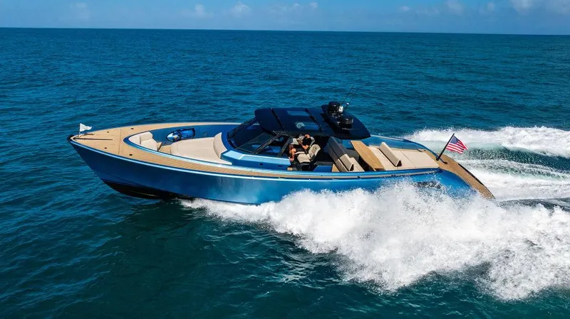 Slide: The Image of Luxury Wajer 55 S yacht cruising on open sea, 2022 model, with sleek design and American flag. - 8