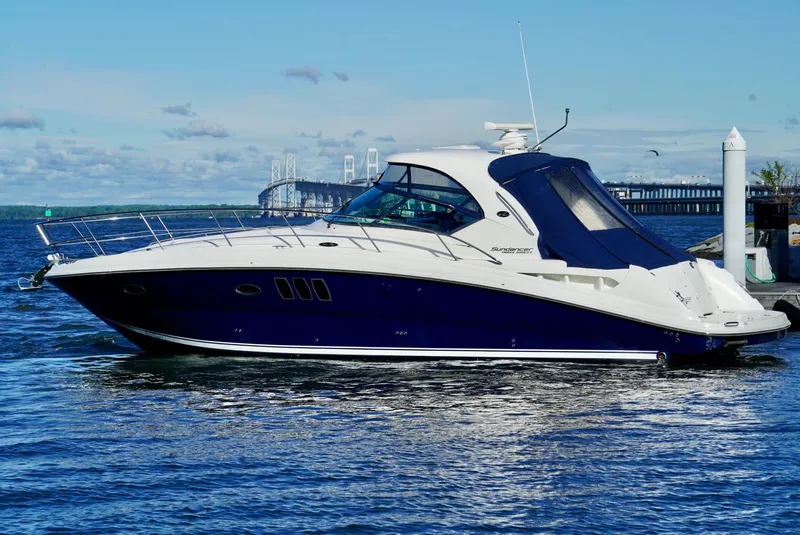 Slide: The Image of 2010 Sea Ray 390 Sundancer yacht on calm water, featuring sleek design and modern amenities. - 11