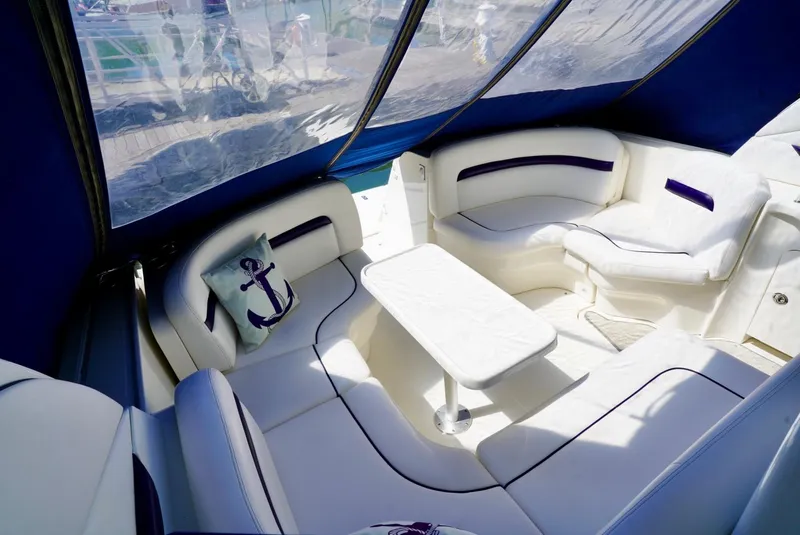 Slide: The Image of Luxurious interior of 2010 Sea Ray 390 Sundancer yacht with white seating and table. - 16