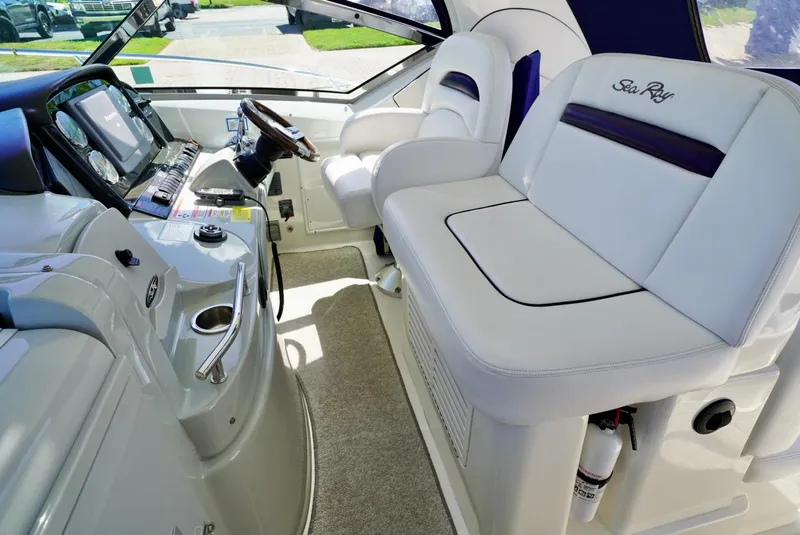 Slide: The Image of Interior of 2010 Sea Ray 390 Sundancer yacht with white seating and modern dashboard. - 17