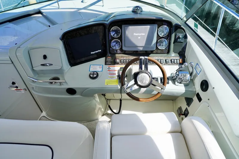 Slide: The Image of Helm of 2010 Sea Ray 390 Sundancer with modern navigation equipment and comfortable seating. - 18