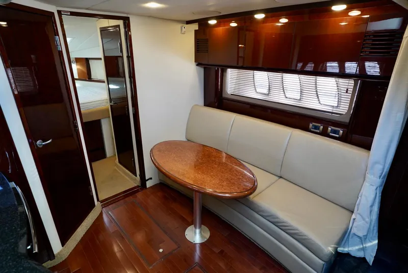 Slide: The Image of Interior of 2010 Sea Ray 390 Sundancer with sofa and wooden table. - 25