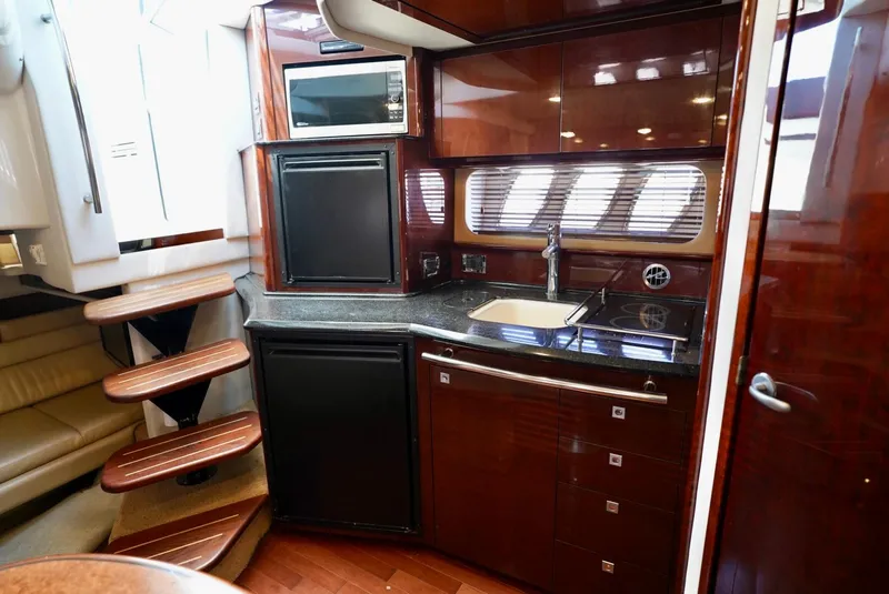 Slide: The Image of Luxurious kitchen interior of 2010 Sea Ray 390 Sundancer yacht with wood finish. - 26