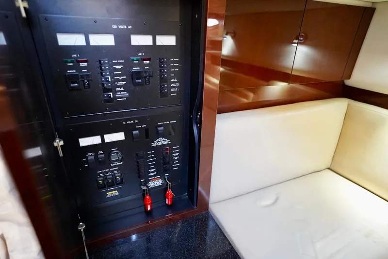 Slide: The Image of Electrical panel and seating area in 2010 Sea Ray 390 Sundancer yacht interior. - 28