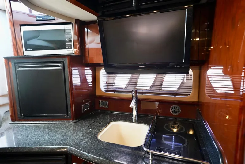 Slide: The Image of Luxurious kitchen area in 2010 Sea Ray 390 Sundancer yacht with modern amenities. - 35
