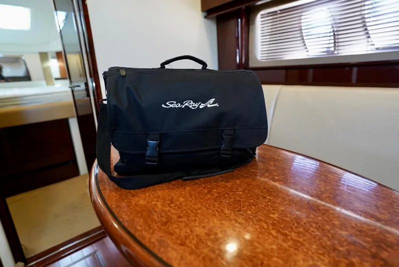 Slide: The Image of Sea Ray 390 Sundancer 2010 interior with branded bag on wooden table. - 36