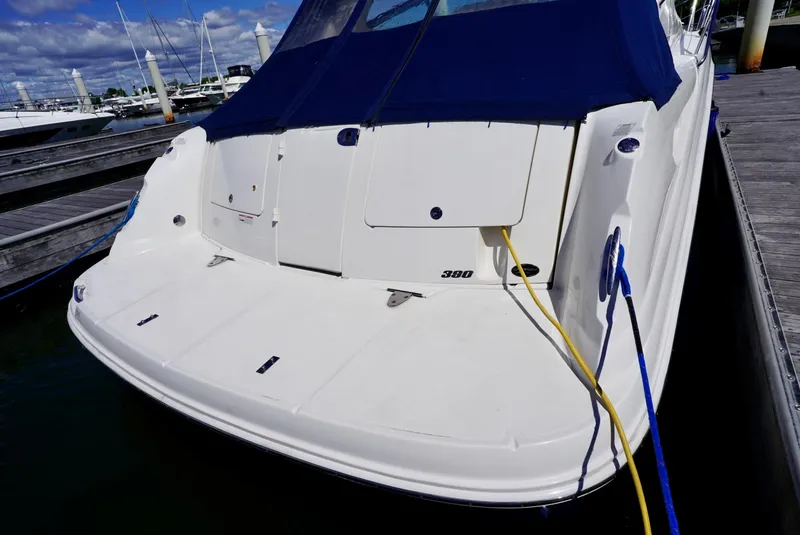 Slide: The Image of Sea Ray 390 Sundancer 2010 docked, rear view with blue cover and power cables. - 38