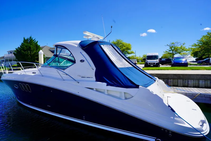 Slide: The Image of 2010 Sea Ray 390 Sundancer yacht docked in a marina under clear blue skies. - 42