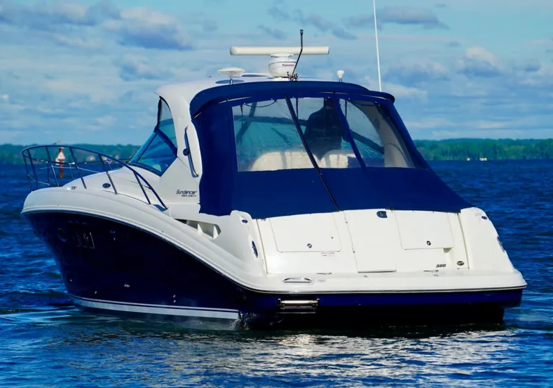 Slide: The Image of 2010 Sea Ray 390 Sundancer yacht on a calm blue lake. - 5