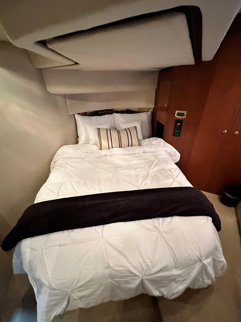 Slide: The Image of Cozy bedroom in 1999 Cruisers 5000 Sedan Sport yacht with plush bedding. - 11
