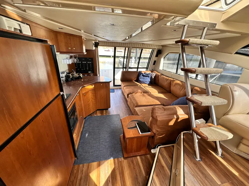 Slide: The Image of Luxurious interior of 1999 Cruisers 5000 Sedan Sport yacht with modern kitchen and cozy seating. - 13