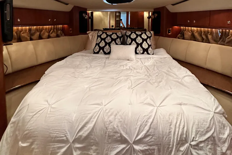 Slide: The Image of Luxurious bedroom interior of 1999 Cruisers 5000 Sedan Sport yacht with plush bedding. - 15