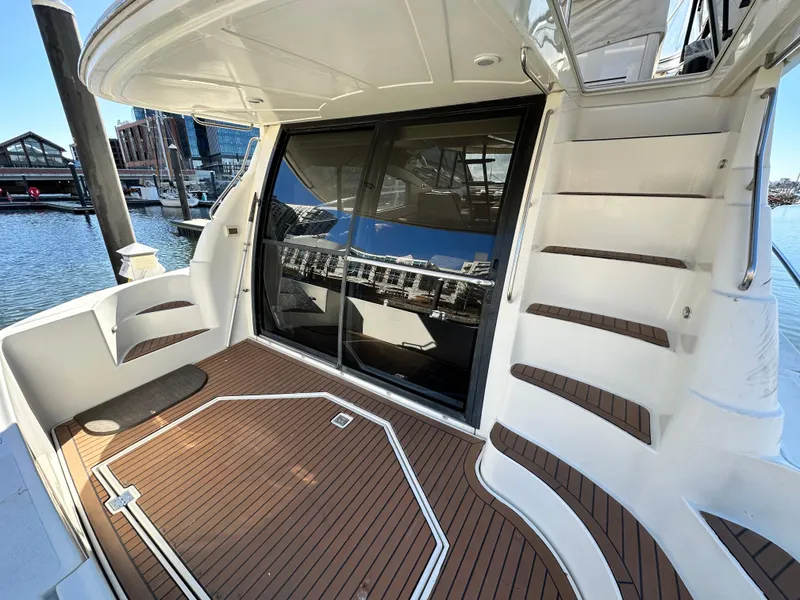 Slide: The Image of 1999 Cruisers 5000 Sedan Sport yacht with sleek deck and modern design. - 2