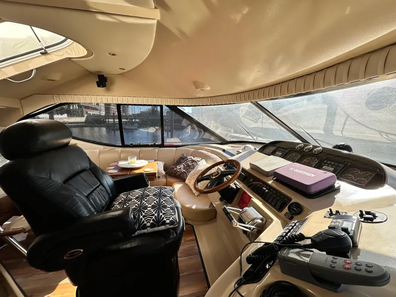Slide: The Image of Interior of 1999 Cruisers 5000 Sedan Sport yacht with leather seating and navigation controls. - 8