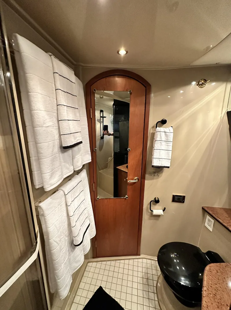 Slide: The Image of Bathroom interior of 1999 Cruisers 5000 Sedan Sport yacht with towels and modern fixtures. - 9