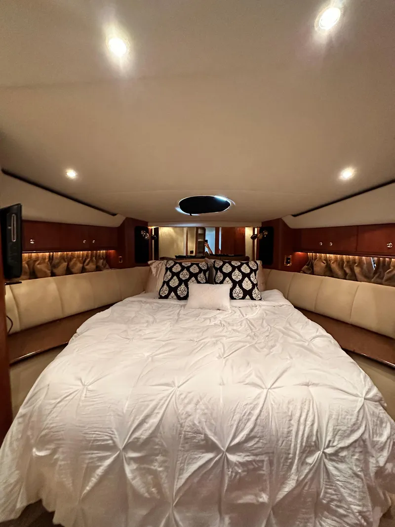 Slide: The Image of Luxurious bedroom interior of 1999 Cruisers 5000 Sedan Sport yacht with elegant bedding. - 10