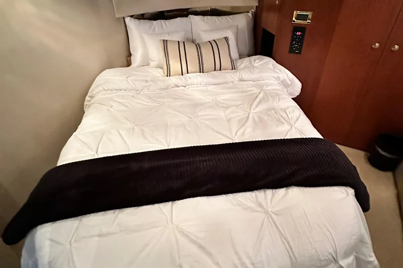 Slide: The Image of Cozy bedroom in 1999 Cruisers 5000 Sedan Sport yacht with plush bedding. - 14