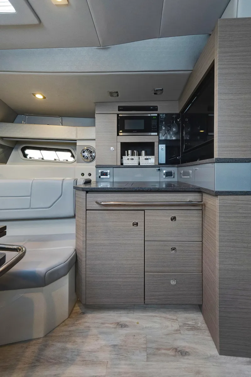 Slide: The Image of 2018 Formula 430 Super Sport Crossover interior with modern kitchen cabinetry and seating. - 16