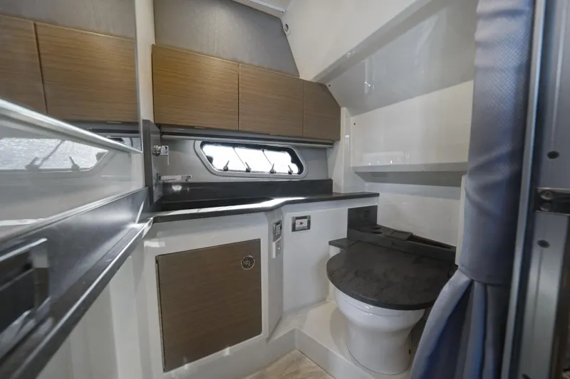 Slide: The Image of 2018 Formula 430 Super Sport Crossover bathroom interior with modern fixtures and wood cabinetry. - 17