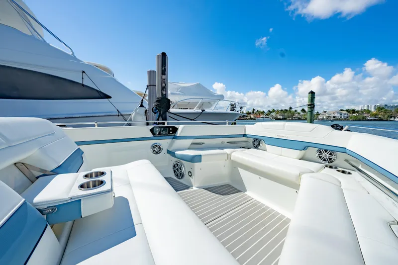 Slide: The Image of 2018 Formula 430 Super Sport Crossover yacht with luxurious seating, docked under a clear blue sky. - 23