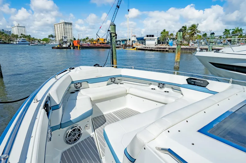 Slide: The Image of 2018 Formula 430 Super Sport Crossover boat docked in a marina, featuring spacious seating. - 24