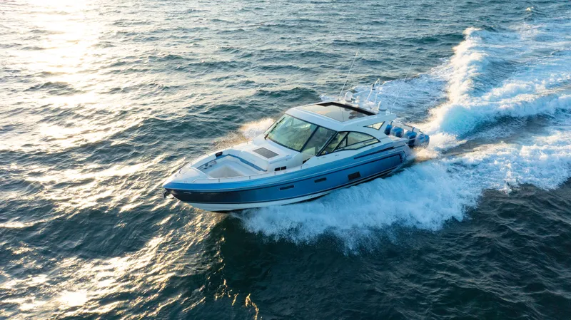 Slide: The Image of 2018 Formula 430 Super Sport Crossover cruising on open water at sunset. - 30