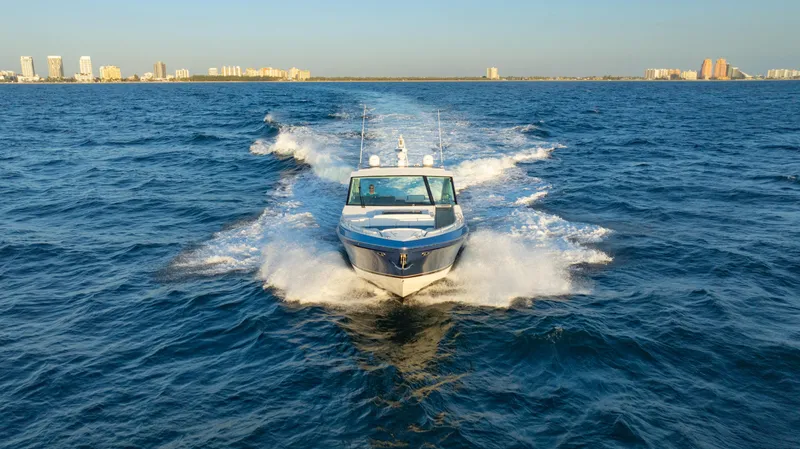 Slide: The Image of 2018 Formula 430 Super Sport Crossover cruising on open water with city skyline in background. - 33