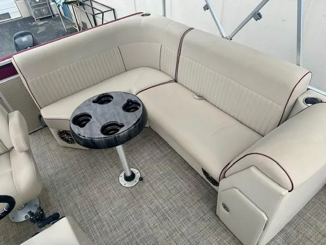 Slide: The Image of Luxurious seating area on a 2019 Qwest 818 boat with a round table and cup holders. - 10