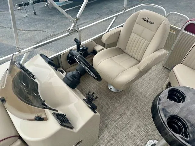 Slide: The Image of 2019 Qwest 818 boat interior with beige captain's chair and steering console. - 11