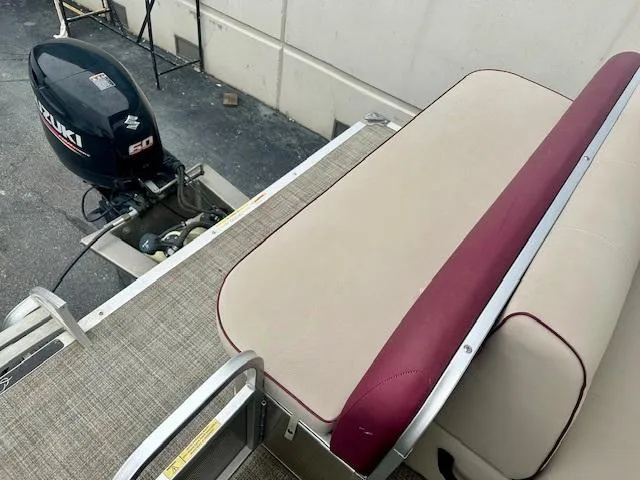 Slide: The Image of Pontoon boat with Suzuki outboard motor, beige and maroon seating, Qwest 818, 2019 model. - 12