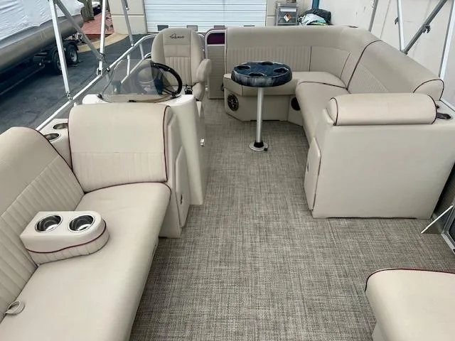Slide: The Image of Luxurious 2019 Qwest 818 pontoon boat interior with beige seating and modern amenities. - 7