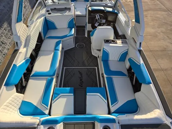 Slide: The Image of 2025 Tigé 24RZX boat interior with blue and white seating, modern design, and spacious layout. - 11