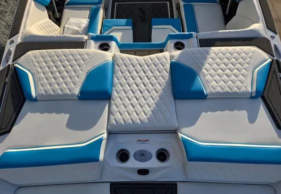 Slide: The Image of 2025 Tigé 24RZX boat interior with blue and white cushioned seating. - 13