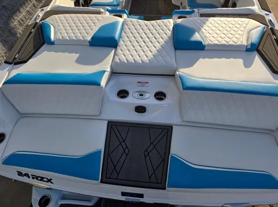 Slide: The Image of 2025 Tigé 24RZX boat with blue and white cushioned seating, rear view. - 14