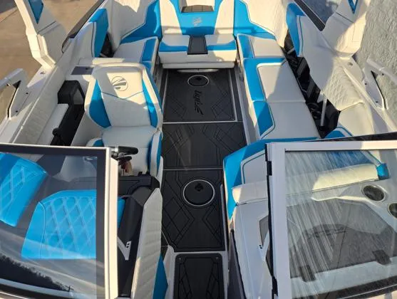 Slide: The Image of 2025 Tigé 24RZX boat interior with blue and white seating, modern design. - 3