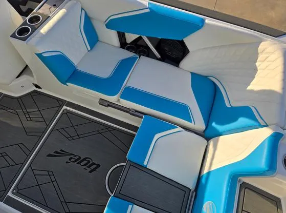 Slide: The Image of 2025 Tigé 24RZX boat interior with blue and white seating, modern design. - 7