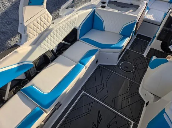 Slide: The Image of 2025 Tigé 24RZX boat interior with blue and white seating, modern design, and stylish flooring. - 9