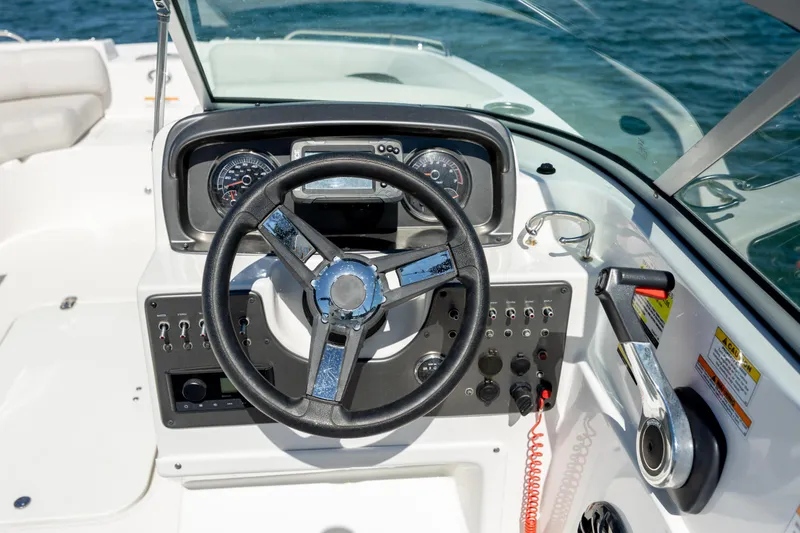 Slide: The Image of 2023 Hurricane SunDeck 187 OB boat dashboard with steering wheel and controls. - 12