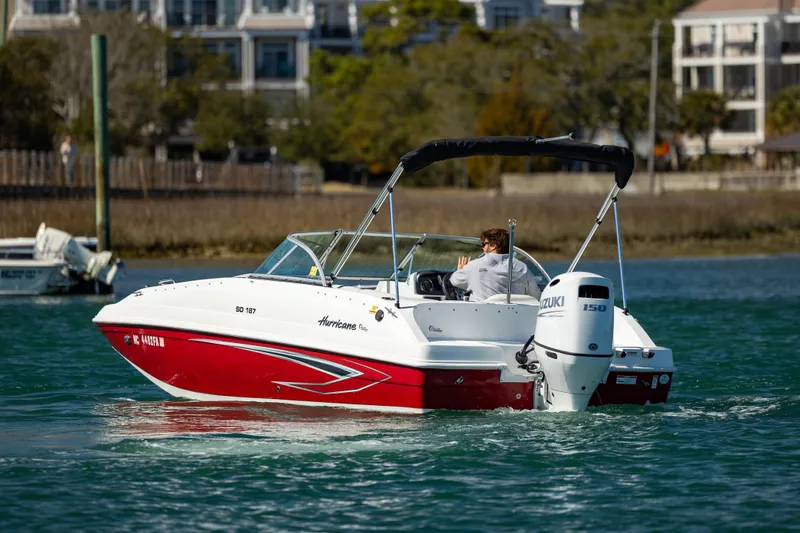 Slide: The Image of 2023 Hurricane SunDeck 187 OB boat cruising on a calm waterway. - 6