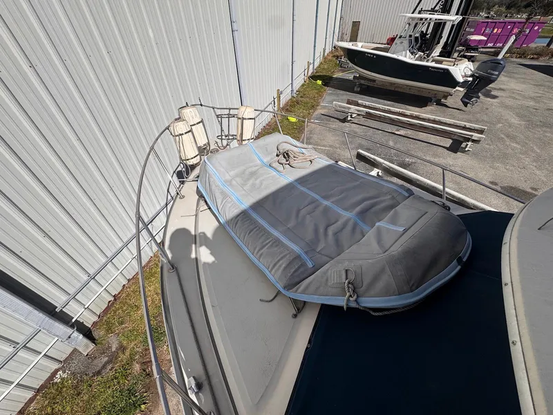 Slide: The Image of 1988 Sea Ray 265 Sedan Bridge boat docked near a metal building. - 10