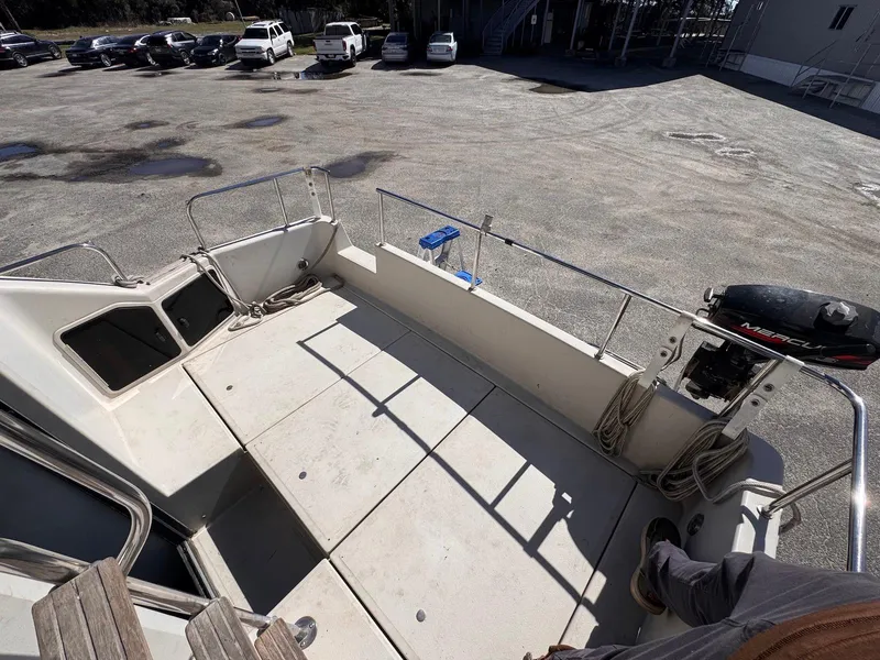 Slide: The Image of 1988 Sea Ray 265 Sedan Bridge boat deck with railing and outboard motor. - 13